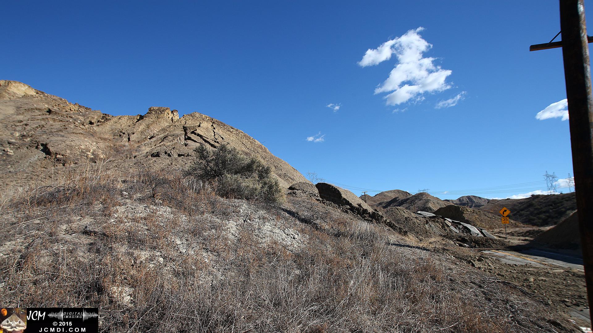 Landslide, buckled pavement, and terrain at Vasquez Canyon Road in Santa Clarita, CA filmed 11-25-2015